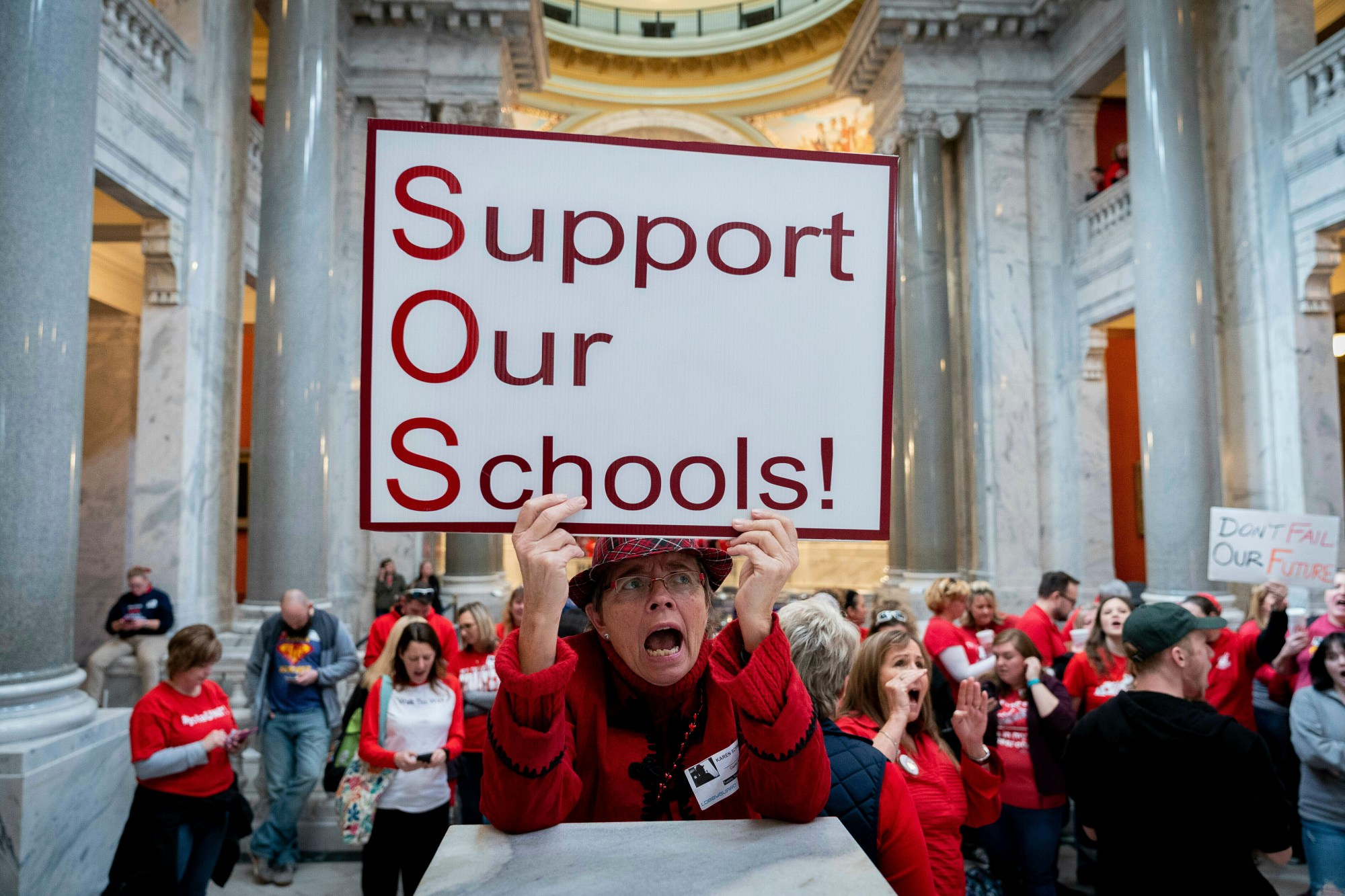 FILE – Karen Schwartz, a teacher at Phoenix School of Discovery in Louisville, stands with other teachers and their supporters to protest perceived attacks on public education on March 12, 2019, in Frankfort, Ky. (AP Photo/Bryan Woolston, File)
